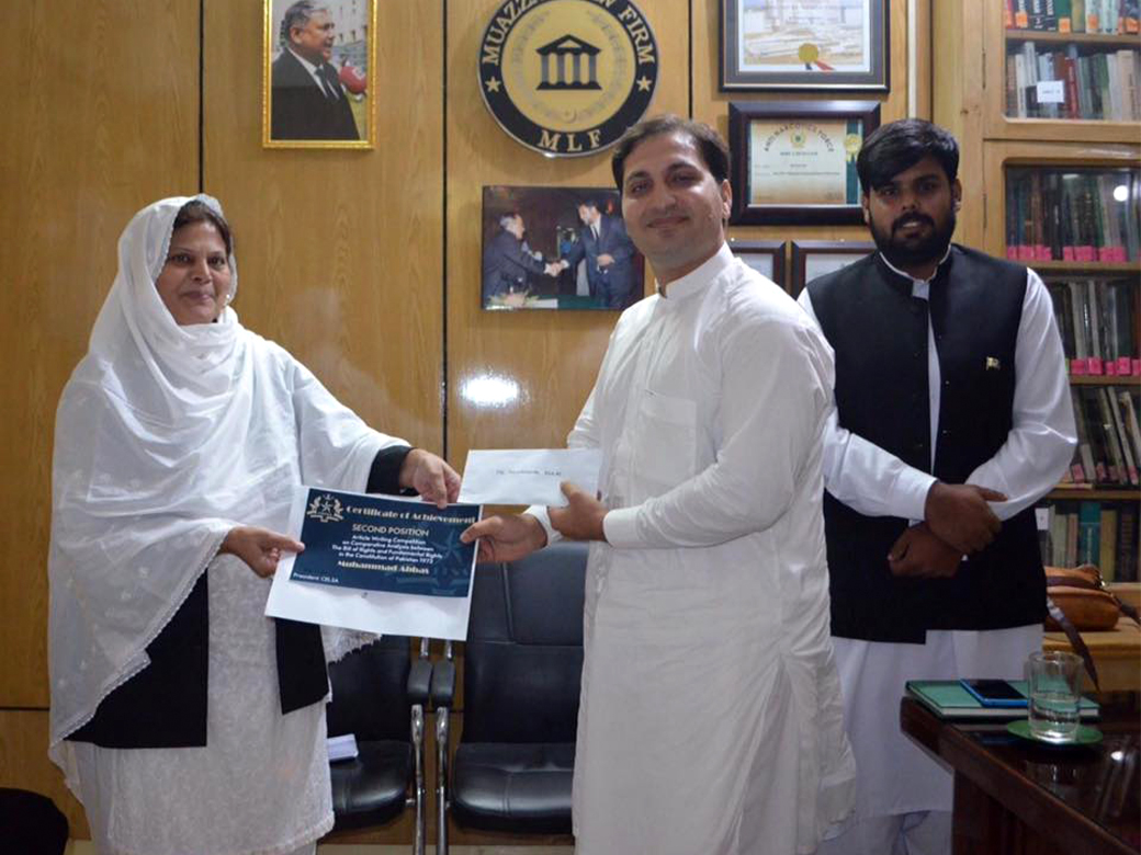 Mr. Muhammad Muhammad Abbas receiving second prize from Mrs. Ummi-Farhat, Co-Chaiperson, MLF. Facilitated by Mr. Israr Ahmed Durrani.